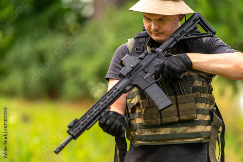 Obraz na płótnie Armed man interacting with a rifle w salonie
