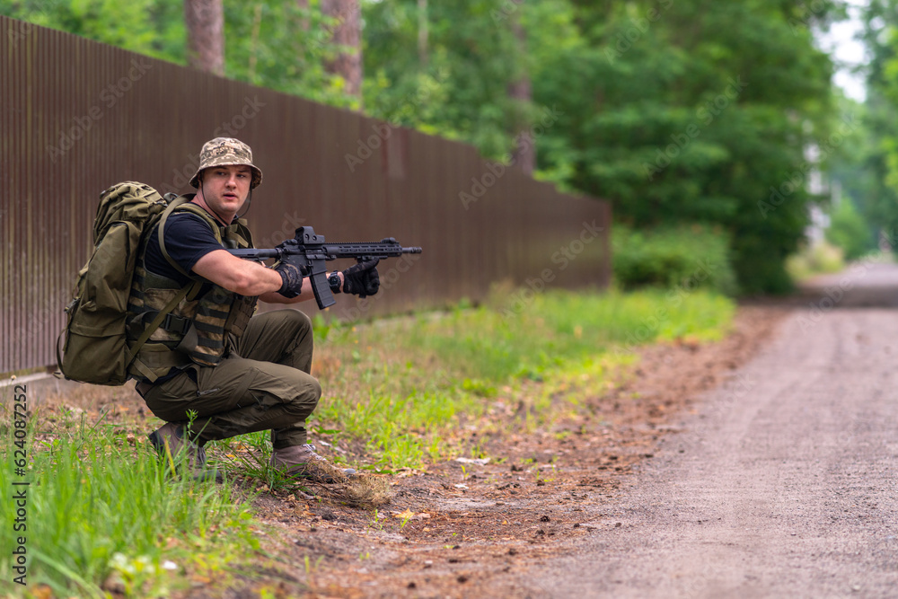 A soldier or mercenary is looking along the sides of the road