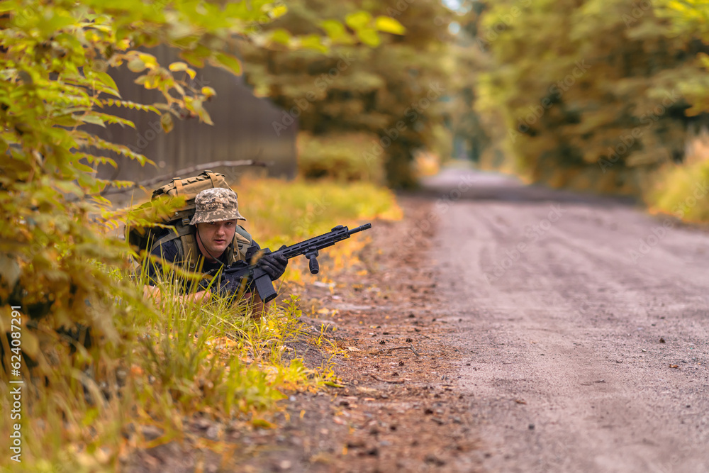 A man with a weapon, took a prone position