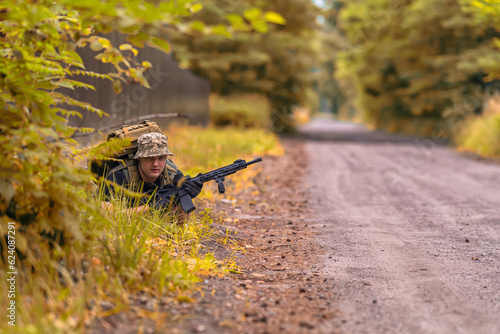 A man with a weapon, took a prone position