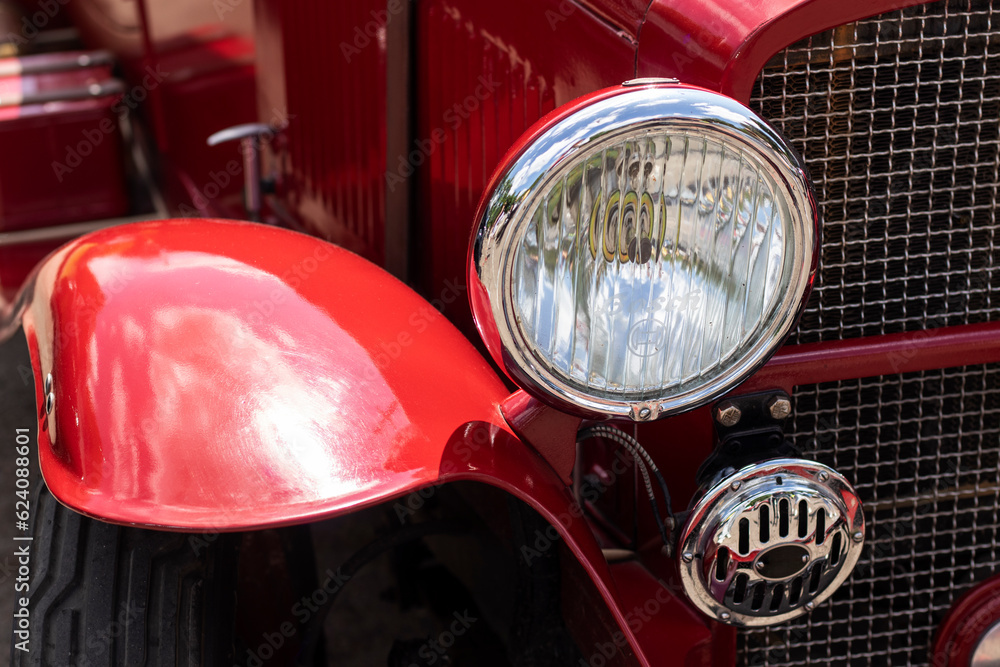 Headlight on a red retro car. Close-up.