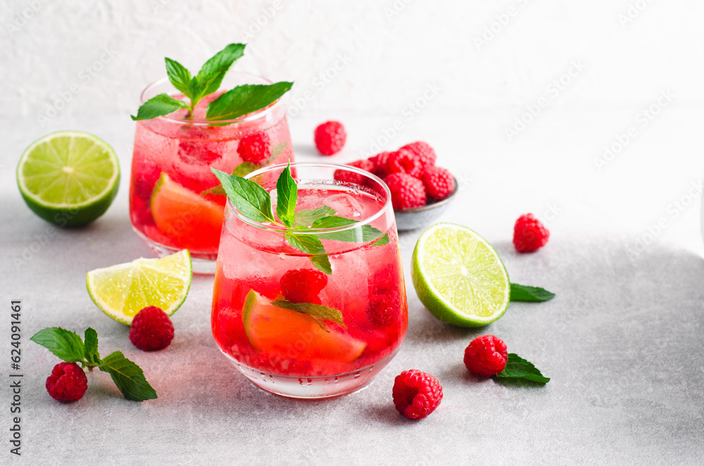Refreshing Cold Cocktail or Mocktail with Berries and Lime, Raspberry Lemonade Refreshing Cold Cocktail or Mocktail with Berries and Lime, Raspberry Lemonade