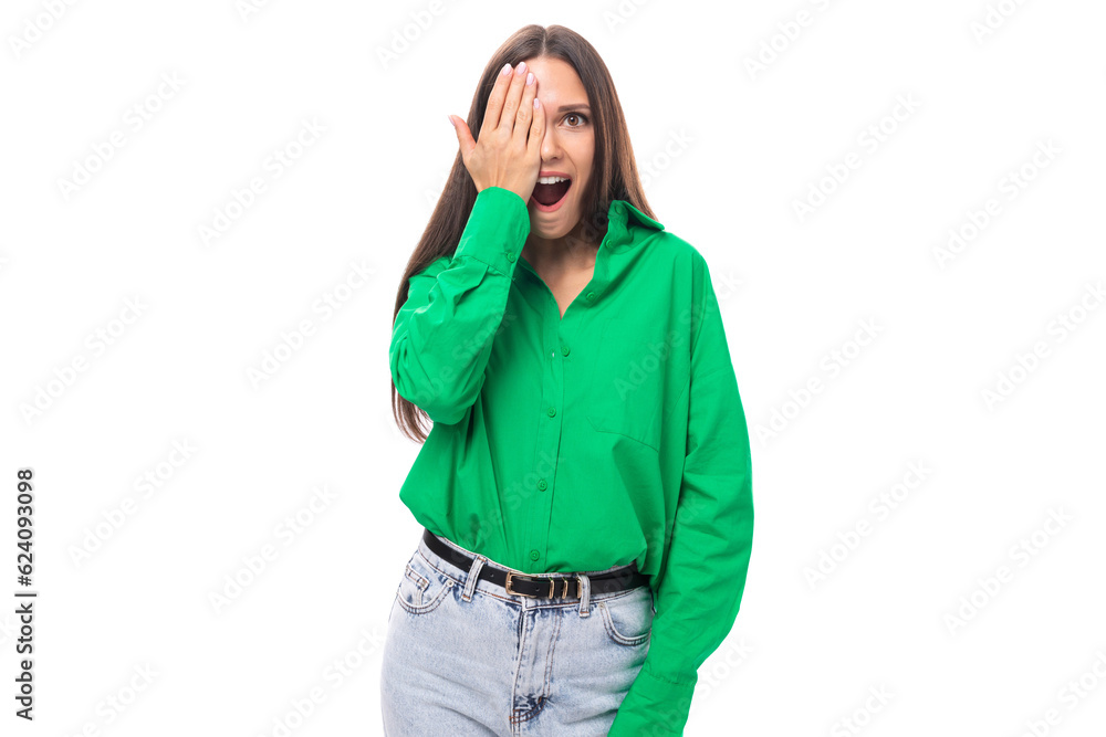 emotional young brown-eyed brown-haired woman with a bright facial expression in a green blouse on a white background with copy space