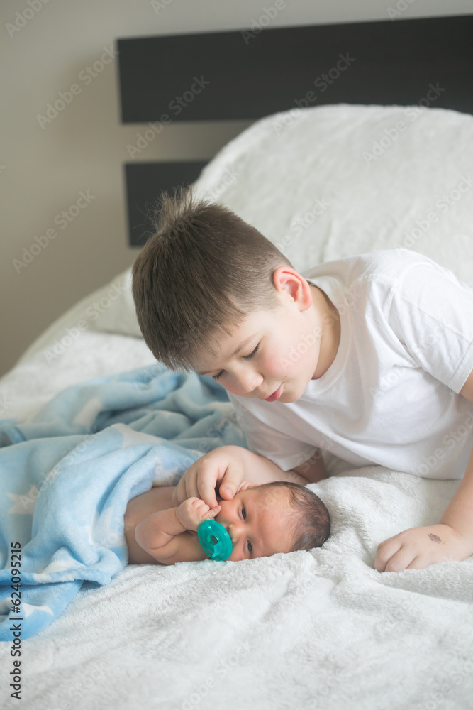 Big brother with his little newborn brother. love family concept Big brother with his little newborn brother. love family concept