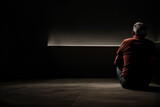 暗い部屋に一人ぼっちで膝を抱える男性の後ろ姿2: AI生成画像 Back view of a man holding his knees, alone in a dark room. generative AI