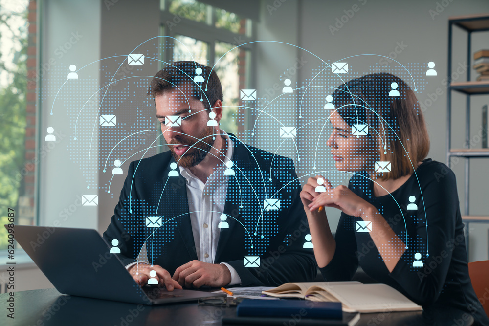 Thoughtful businesspeople typing on laptop at office workplace. Concept of team work, business education, internet surfing, brainstorm, project information technology. Social network hologram