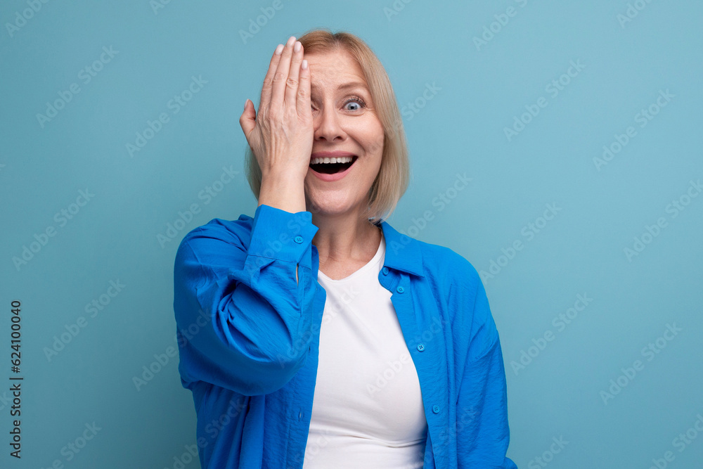 smiling middle aged woman on blue background copy space smiling middle aged woman on blue background copy space