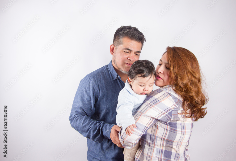 Beautiful photo of mom and dad holding baby on light photo studio background. Family and baby concept. Beautiful photo of mom and dad holding baby on light photo studio background. Family and baby concept.