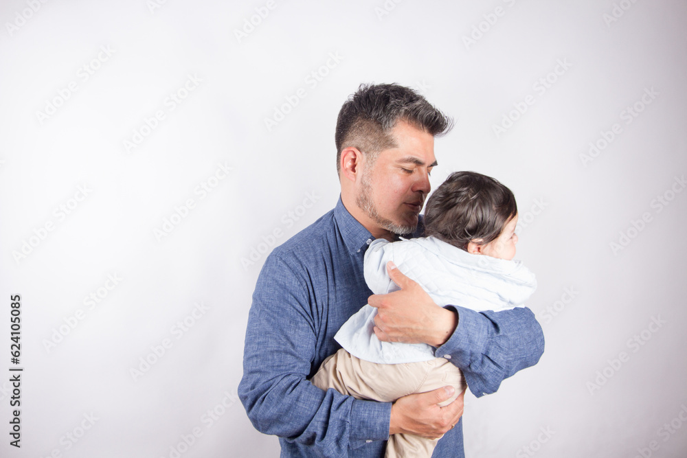 Beautiful photo of dad holding baby on light photo studio background. Family and baby concept. Beautiful photo of dad holding baby on light photo studio background. Family and baby concept.