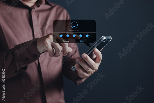 a businessman using application on smartphone the virtual screen to give satisfaction in service.rating star very impressed.customer service and satisfaction concept.