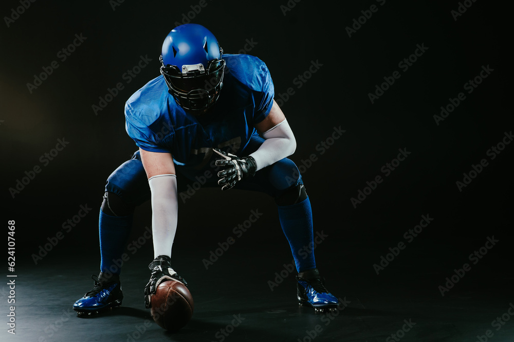 American football player is ready to start the game on a black background.
