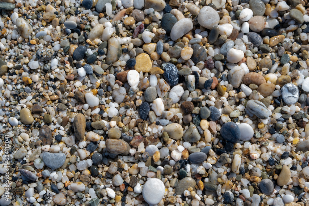 Crushed stone on the seashore. Selective focus on object. The stones were laid on the ground in the garden as a background. Background blur. Pebble stones background. Crushed stone on the seashore. Selective focus on object. The stones were laid on the ground in the garden as a background. Background blur. Pebble stones background.