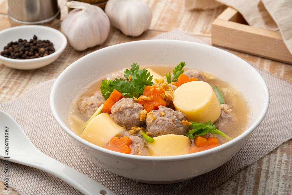 Close up Clear glass noodle soup with Minced Pork,Vegetables and egg tofu (Gaeng Jued Woon Sen) Close up Clear glass noodle soup with Minced Pork,Vegetables and egg tofu (Gaeng Jued Woon Sen)