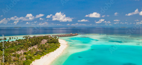 Maldives paradise island. Tropical aerial landscape, seascape pier, water bungalows villas amazing sea lagoon beach. Exotic tourism destination, summer vacation. Beautiful nature, palm trees sea sky © icemanphotos
