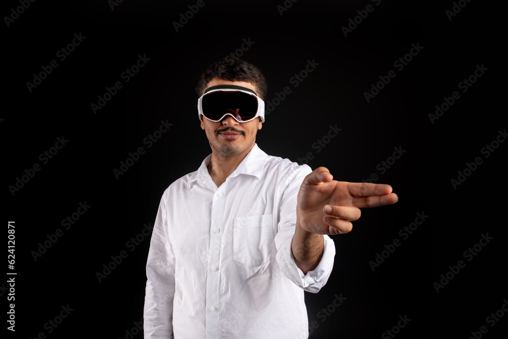 Businessman wearing new vision pro VR glasses, touching virtual screen or objects by fingers interacting with cyberspace Businessman wearing new vision pro VR glasses, touching virtual screen or objects by fingers interacting with cyberspace