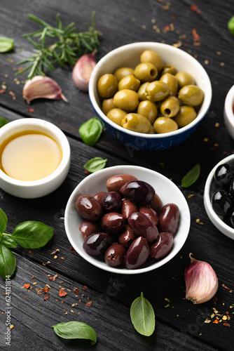 Assortment of fresh green, kalamata and black olives in bowl. Healthy snack