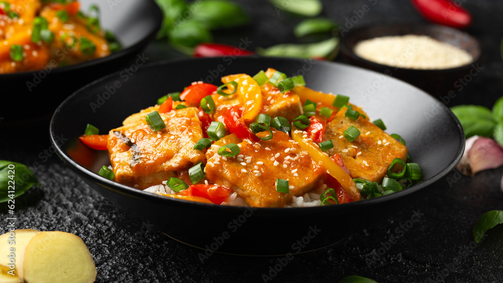 Homemade Stir Fry Tofu with Vegetables and Rice in black bowl. Homemade Stir Fry Tofu with Vegetables and Rice in black bowl.