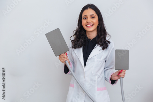 Caucasian Brazilian woman, wearing lab coat, with cryolipolysis machine, weight loss through fat freezing. holding handles for application. photo