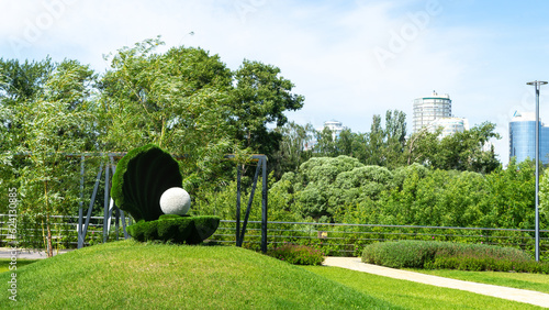 Valokuva Garden and park sculpture made of artificial grass in form of sea shell with pearl on embankment of Iset River in Yekaterinburg, Sverdlovsk Region, Russia