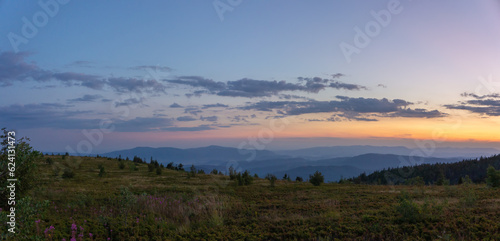 Mountain landscape in the evening  forest at sunset. Picturesque  calm view  serene mood of a summer evening