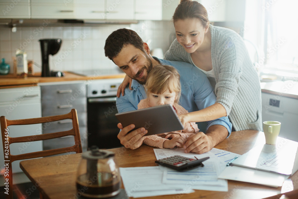 Young family using a digital tablet in the morning Young family using a digital tablet in the morning