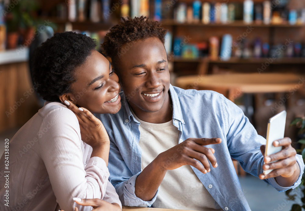 Young black couple taking selfie on smartphone at coffee shop Young black couple taking selfie on smartphone at coffee shop