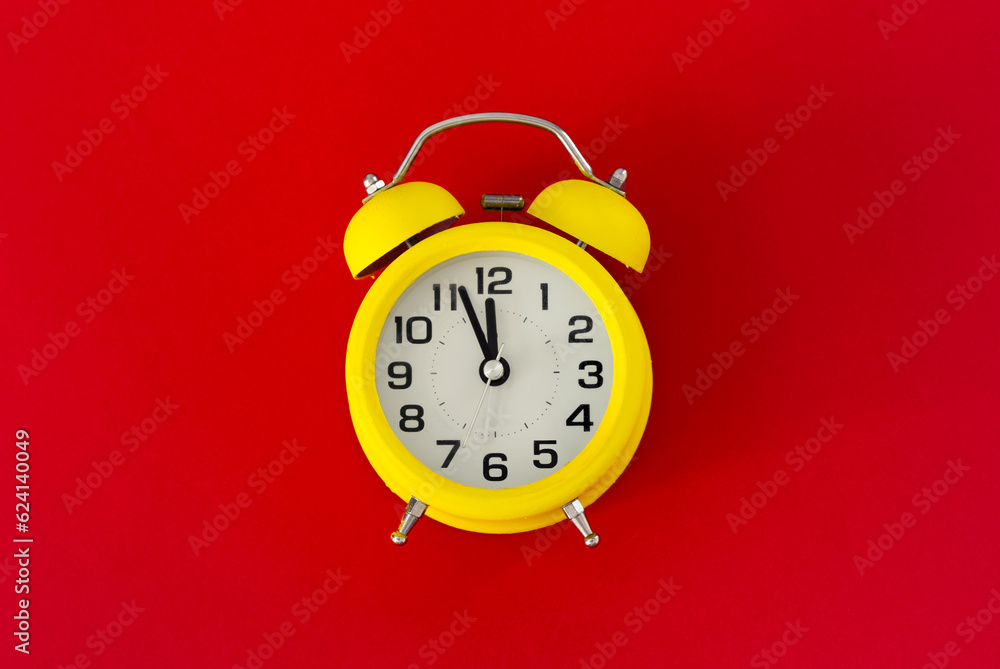Yellow classic desktop clock the red background Yellow classic desktop clock the red background