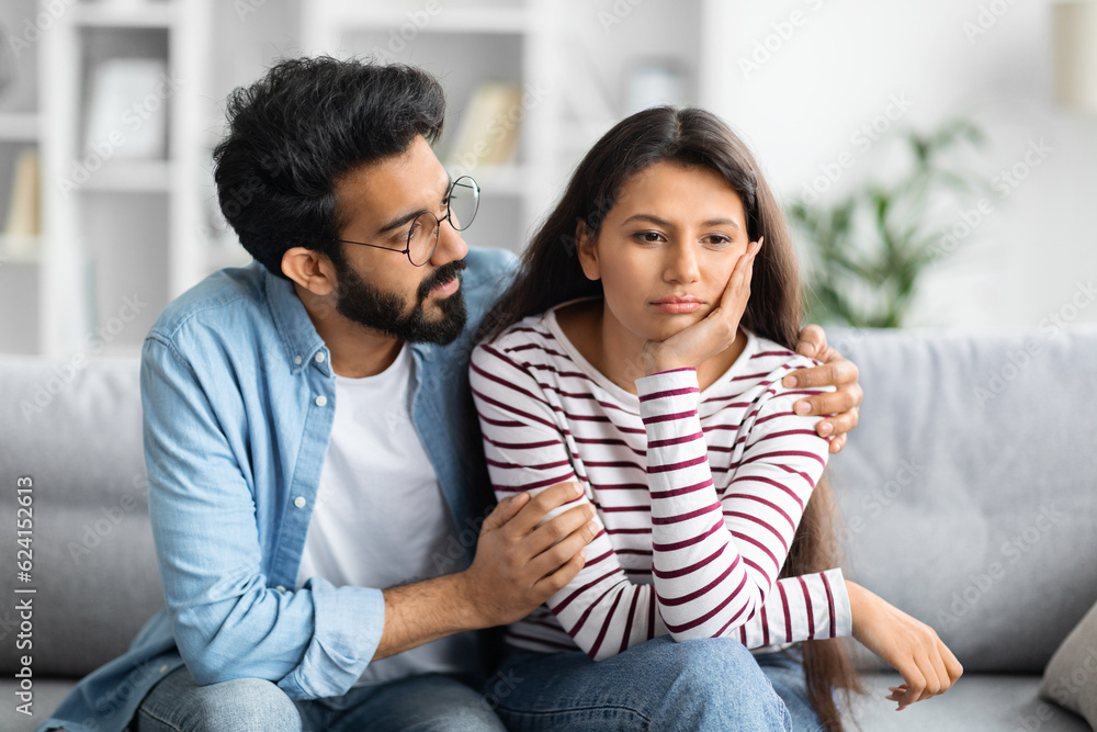 Compassionate husband giving comfort and support to upset wife Compassionate husband giving comfort and support to upset wife