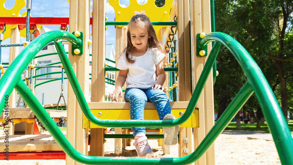 little child having fun at playground. Children's outdoor games. little child having fun at playground. Children's outdoor games.