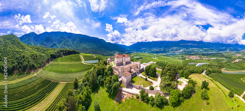 Medieval beautiful castles of northern Italy  - splendid Thun castel amongst the apple trees of Val di Non. Trentino region, Trento province.  Aerial drone panoramic view photo