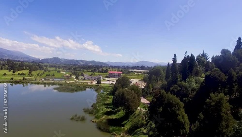 Aerial top view of blue lakes with islands and green forests in colombia. Beautiful summer landscape. photo