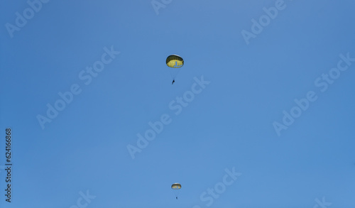 Military parachute training. parachutists in the blue sky.