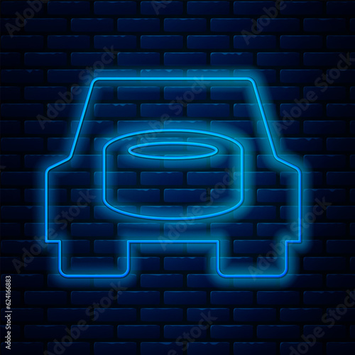 Glowing neon line Spare wheel in the car icon isolated on brick wall background. Process of replacing the wheel. Storage location of the spare wheel in the trunk. Vector