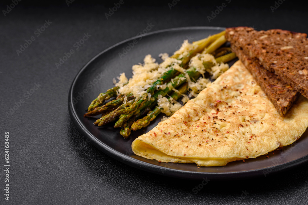 Delicious nutritious breakfast consisting of asparagus, scrambled eggs, salt, spices and herbs
