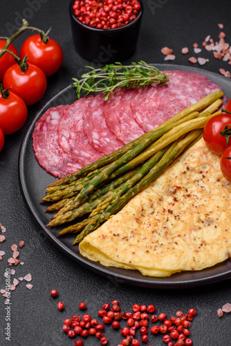 Delicious nutritious breakfast consisting of asparagus, scrambled eggs, salt, spices and herbs