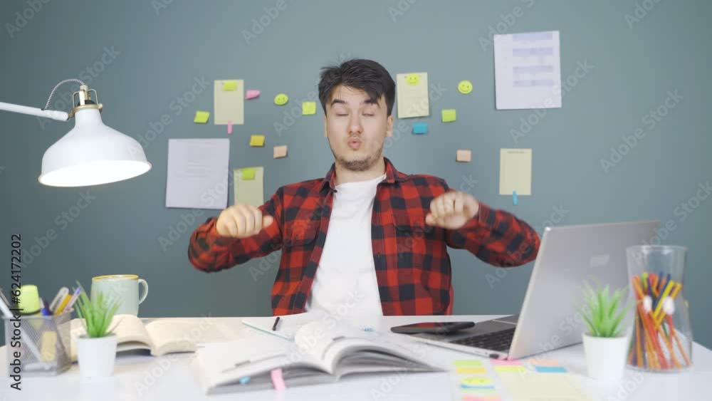 The male student who finishes the homework is happy and peaceful. The male student who finishes the homework is happy and peaceful.