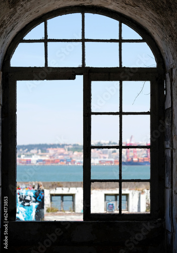 Looking out the window of an abandoned building in Lisbon  Portugal  during a sunny day