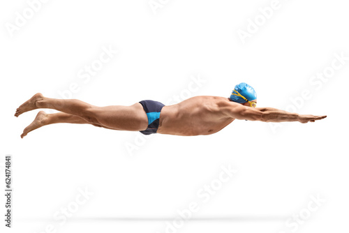 Full length profile shot of a male swimmer with a cap swimming