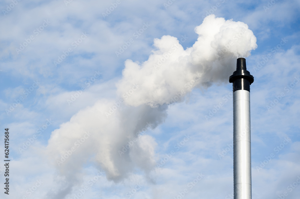 Flue chimney and smoke against blue sky Flue chimney and smoke against blue sky