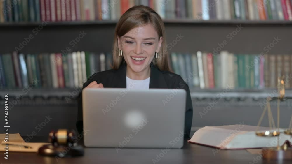 Excited Young Female Lawyer Celebrating Success on Laptop Excited Young Female Lawyer Celebrating Success on Laptop