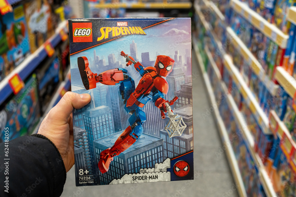 Naklejka premium Lego Spiderman in hands of buyer. Spiderman toy in a toy store. Spider-Man is a fictional superhero in American comic books published by Marvel Comics. Minsk, Belarus, 2023