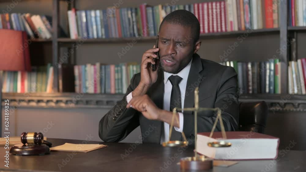 Upset African American Lawyer Arguing on Phone in Office Upset African American Lawyer Arguing on Phone in Office