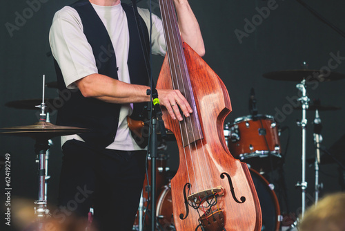 Photography Concert view of a contrabass violoncello player with vocalist and musical rock b