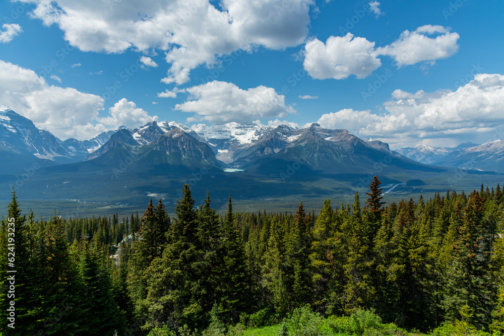 Incredible summer time mountain views in Banff National Park with vast landscape surrounding the national park area. Snow capped mountains near Lake Louise. 