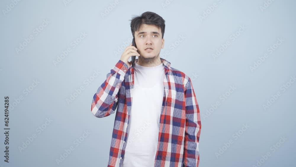 Man getting bad news on the phone gets upset. Man getting bad news on the phone gets upset.