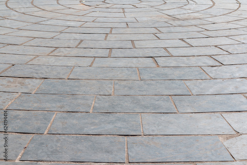 Photograph of smooth stone tiled floor in circular pattern.