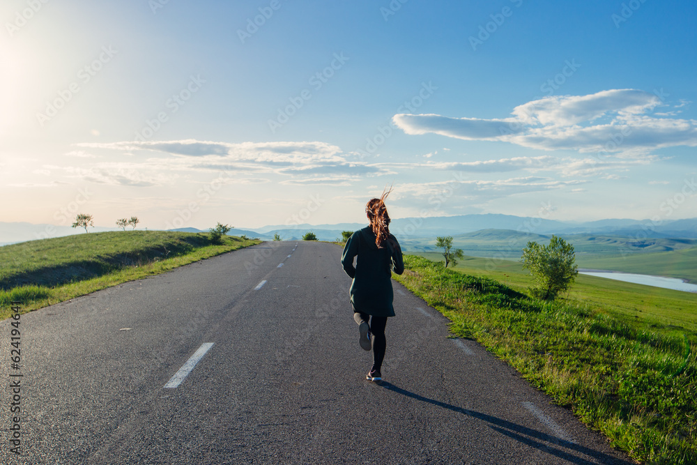 Young fitness woman running on highland road Young fitness woman running on highland road