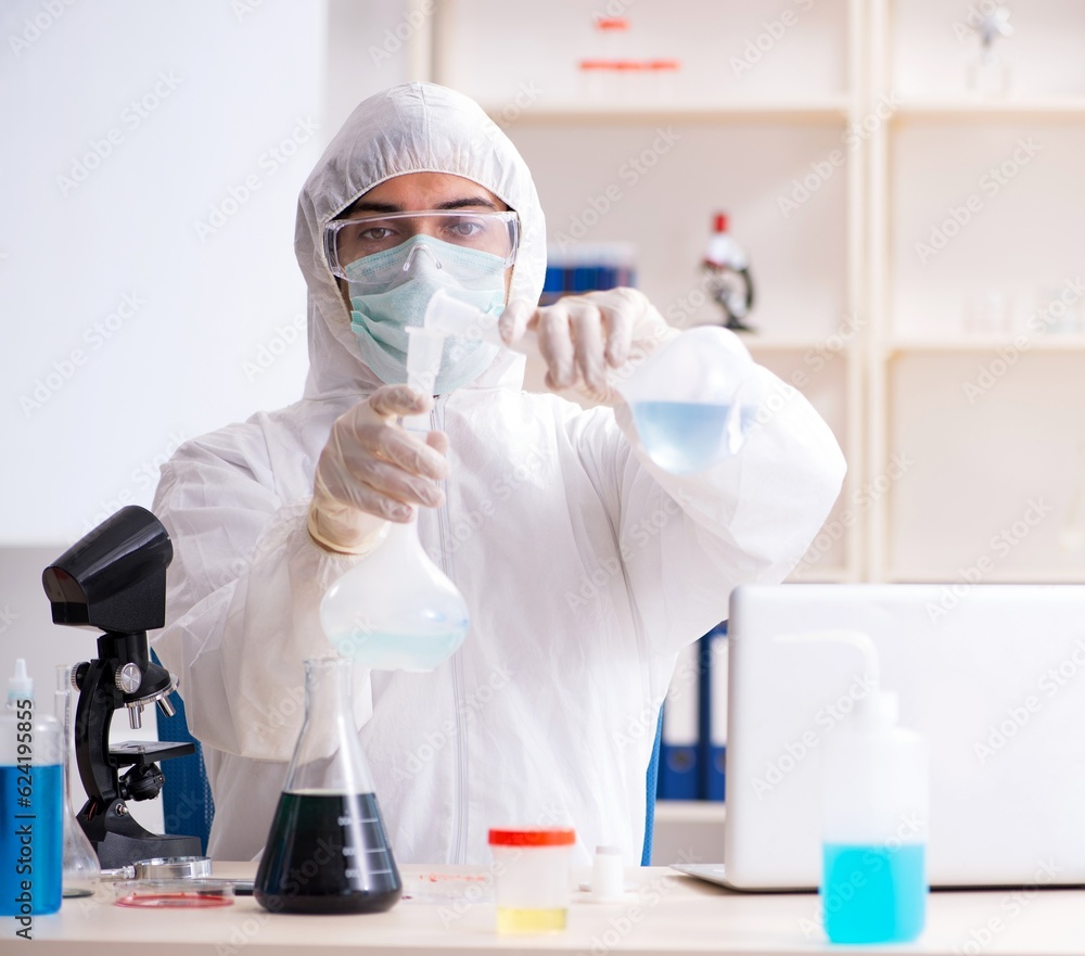 Young handsome chemist working in the lab Young handsome chemist working in the lab