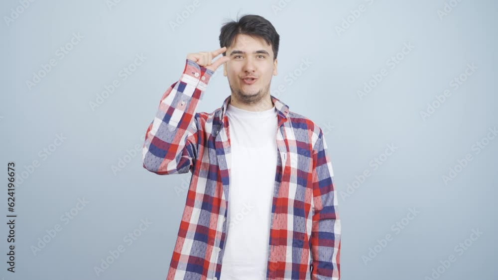 The man making the small sign with his hand. The man making the small sign with his hand.