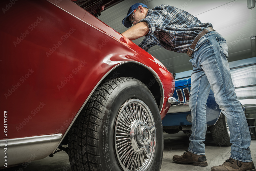 Classic Muscle Car Restoration Performed by Caucasian Professional Mechanic in His 40s. Classic Muscle Car Restoration Performed by Caucasian Professional Mechanic in His 40s.
